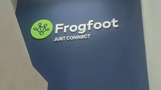 Dimensional Frogfoot logo and lettering mounted on an interior stairwell wall