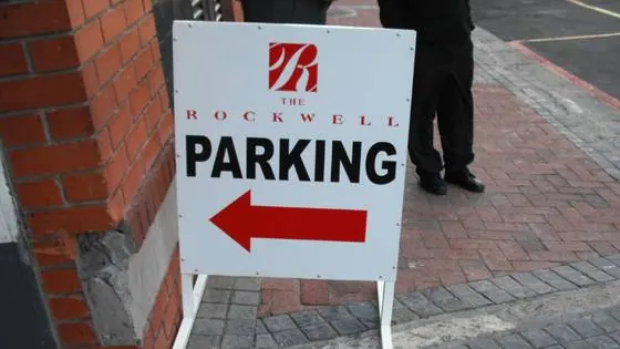 Double-sided A-frame pavement sign directing visitors to Rockwell parking