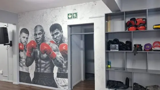 Full-wall printed graphic of boxers installed in a gym interior