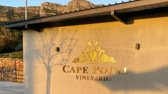 Gold flat-cut lettering and crest mounted on the exterior wall of Cape Point Vineyards