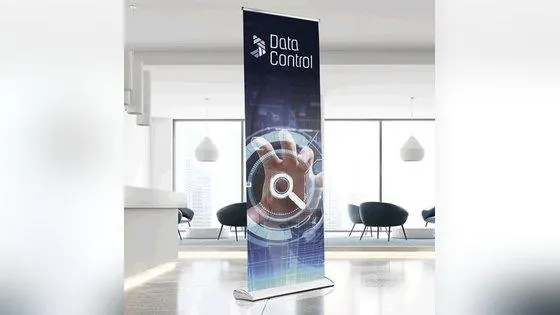 Printed roll-up banner on a silver cassette base standing in an office reception